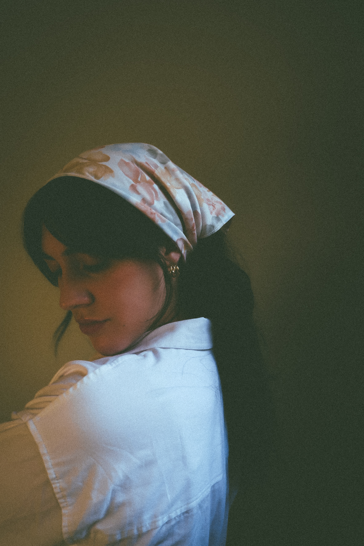 Film portrait of a woman in a floral headscarf